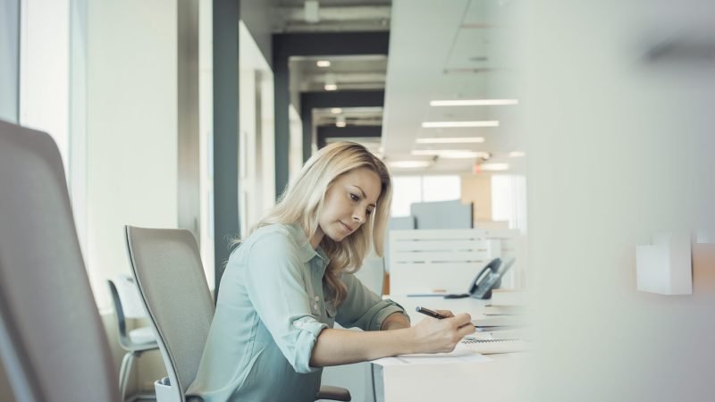 Businesswqoman working alone in office