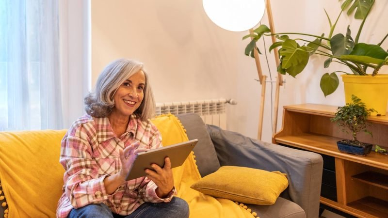 gray-haired-mature-woman-smart-home-home-control-on-tablet-use-smart-home-app.jpg