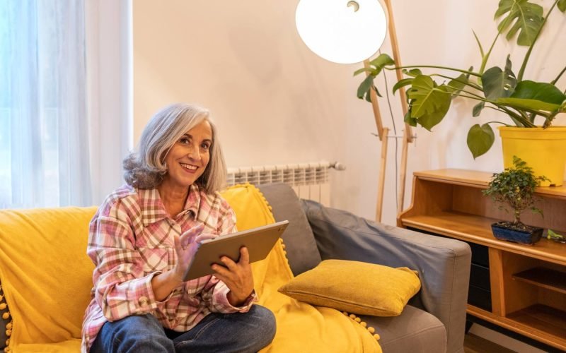 gray-haired-mature-woman-smart-home-home-control-on-tablet-use-smart-home-app.jpg