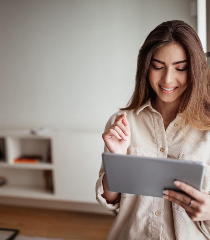 smiling-pretty-young-asian-lady-in-casual-use-tablet-for-control-smart-home-enjoy-study-and-work.jpg